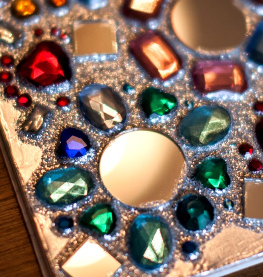 Plastic gems and glass mirrors are glued on the notebook cover.