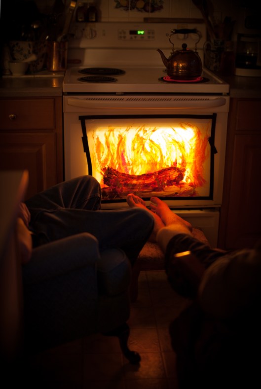 Oven Fireplace. Actually, we taped plastic wrap to the oven with electrician's tape. And then painted the logs and flames with acrylic paint. 