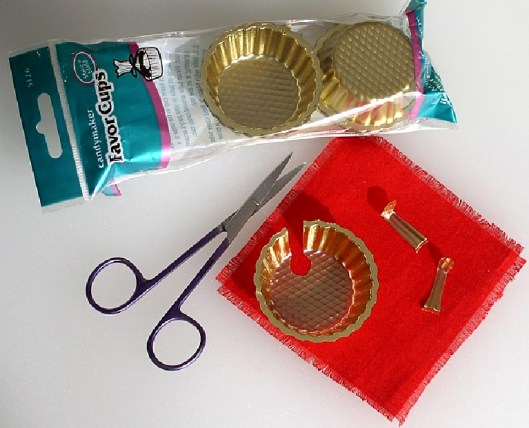 Cut a spoon shape from the side and bottom of a gold candy cup