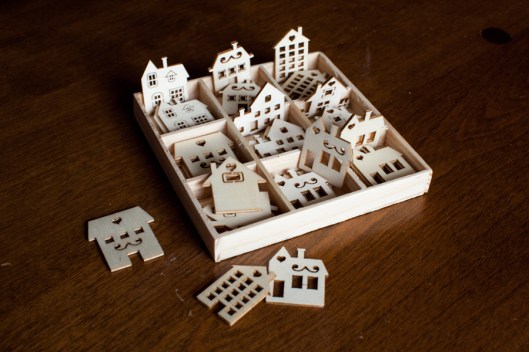 Tiny laser-cut wood houses. These are about 1 1/8" in height.