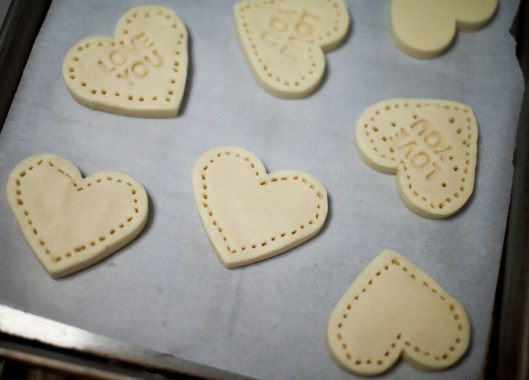 One side of the cutter featured Valentine's Day sentiments, which were pressed into the shortbread. We also used a fork to press holes around the edges of the cookies.
