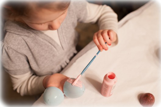 Painting plastic eggs.