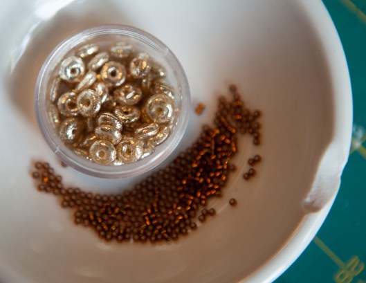 Beads in a small condiment dish.