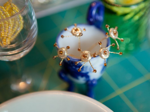 Gold and bronze bead flower centers await petals and assembly.