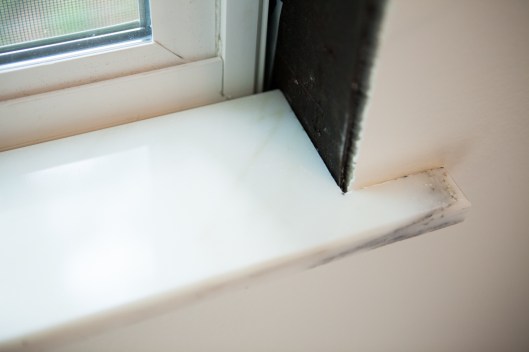 The marble sill pressed in place.