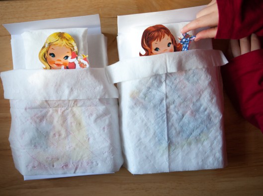 My granddaughter tucks a little "favorite stuffy" next to each paper dollie, tucked under her tissue sheets.