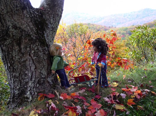 Dolls raking leaves