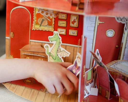 The Dragon tries to keep playing the piano, despite the antics of the Horse.