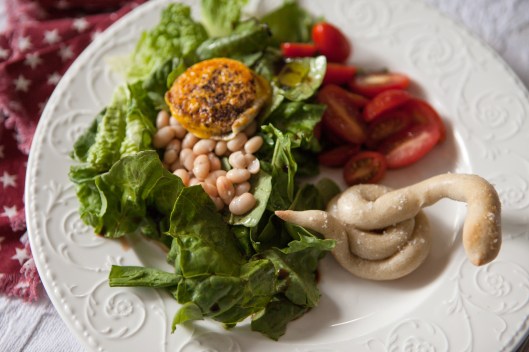 Salad with beans and Fried Egg Yolk and a Sourdough Breadstick Cobra