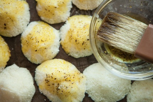 The little cutouts from the rolls are brushed with herb dipping oil and baked in on a separate pan. 