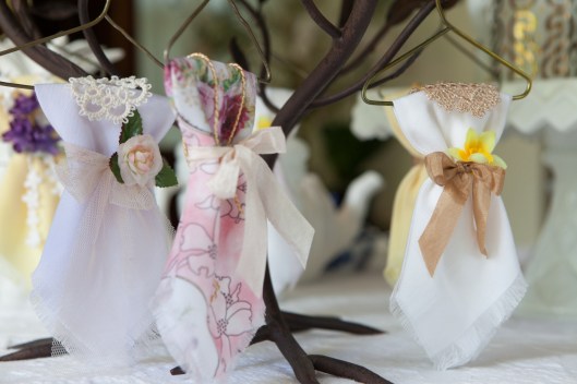 7 Napkins hung like little dresses