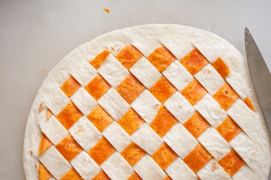 Strips of Habanero tortilla are woven through slits in a white flour tortilla.
