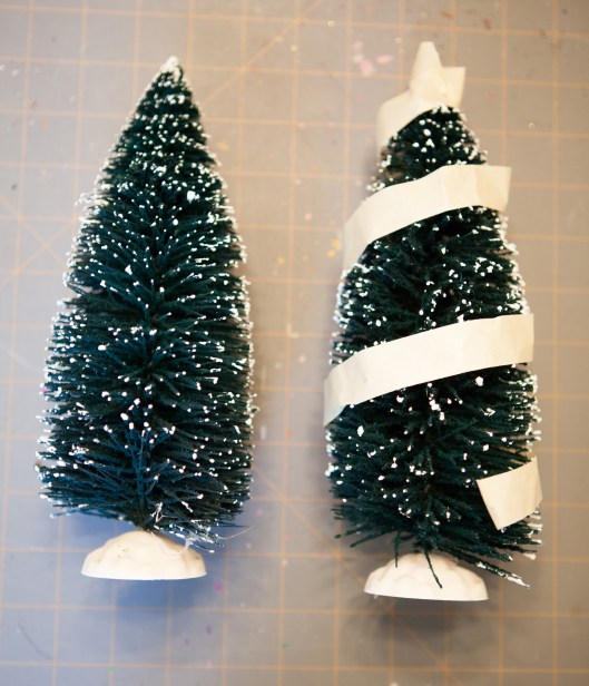 The masking tape is wound around the tree, starting at the bottom and spiraling around the tree to the top. The tape will mark all the places that the bristles will NOT be cut.