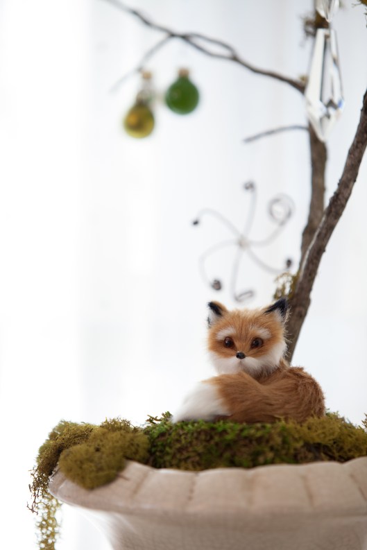 A furry, little red fox ornament sits at the base of the Snow and Crystal Tree. 