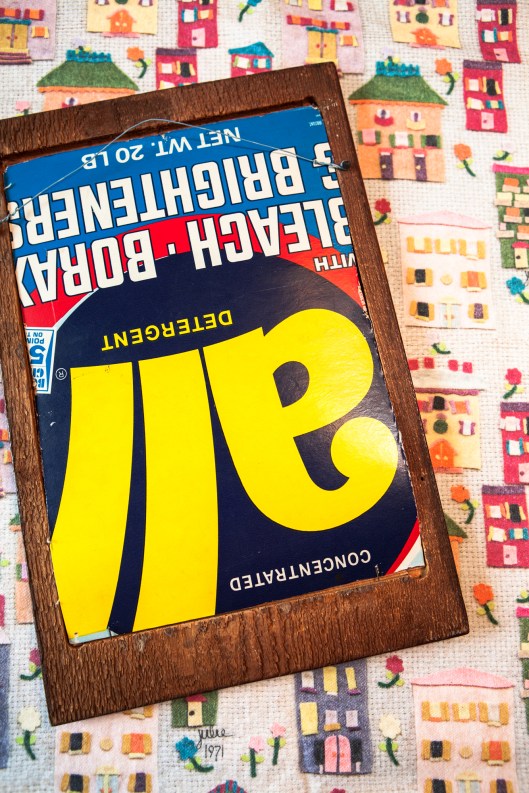 The back of the Felt Houses artwork, clued to a piece of cardboard from a box of All laundry detergent.