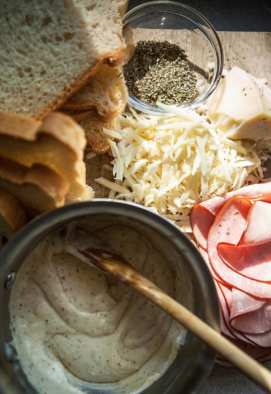 Ingredients for Croque Monsieur. Sliced homemade bread, sliced ham, gruyere cheese, Herbs de Provence, mustard bechemel. 